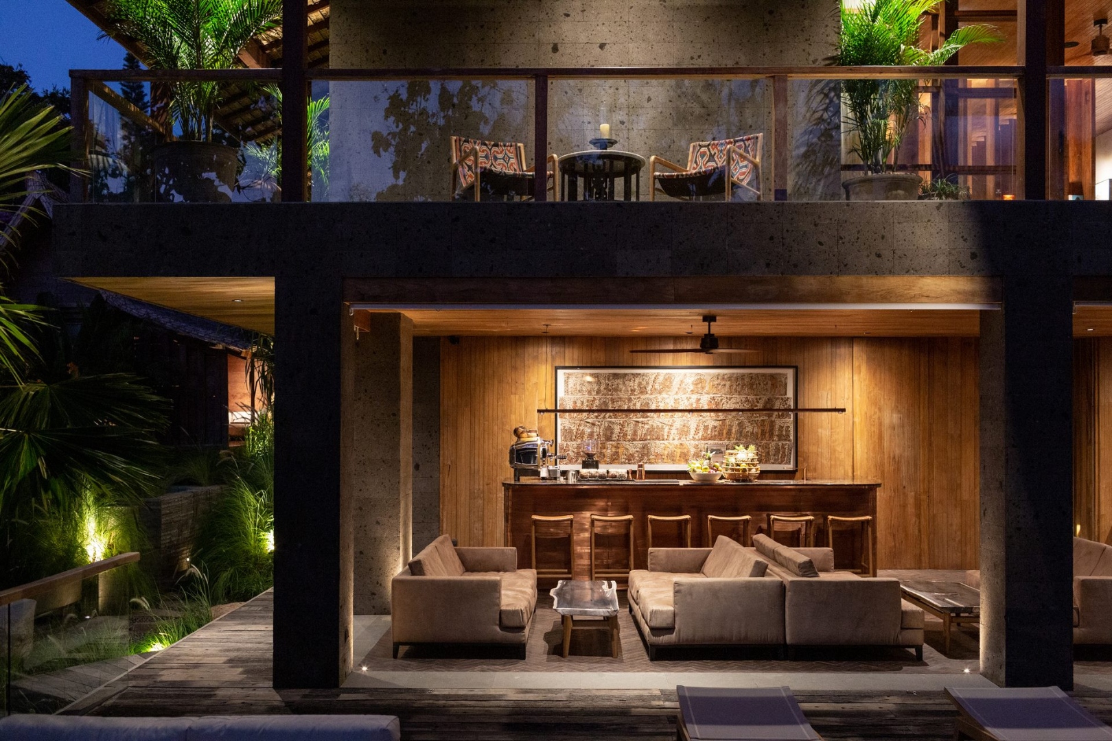 The Asa Maia open-air bar and lounge at dusk — teak woodwork and warm lighting, Uluwatu Bali