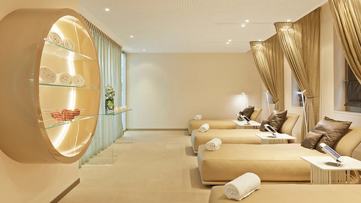 Clinique La Prairie spa relaxation lounge — luxury wellness retreat day beds with designer lighting, Montreux