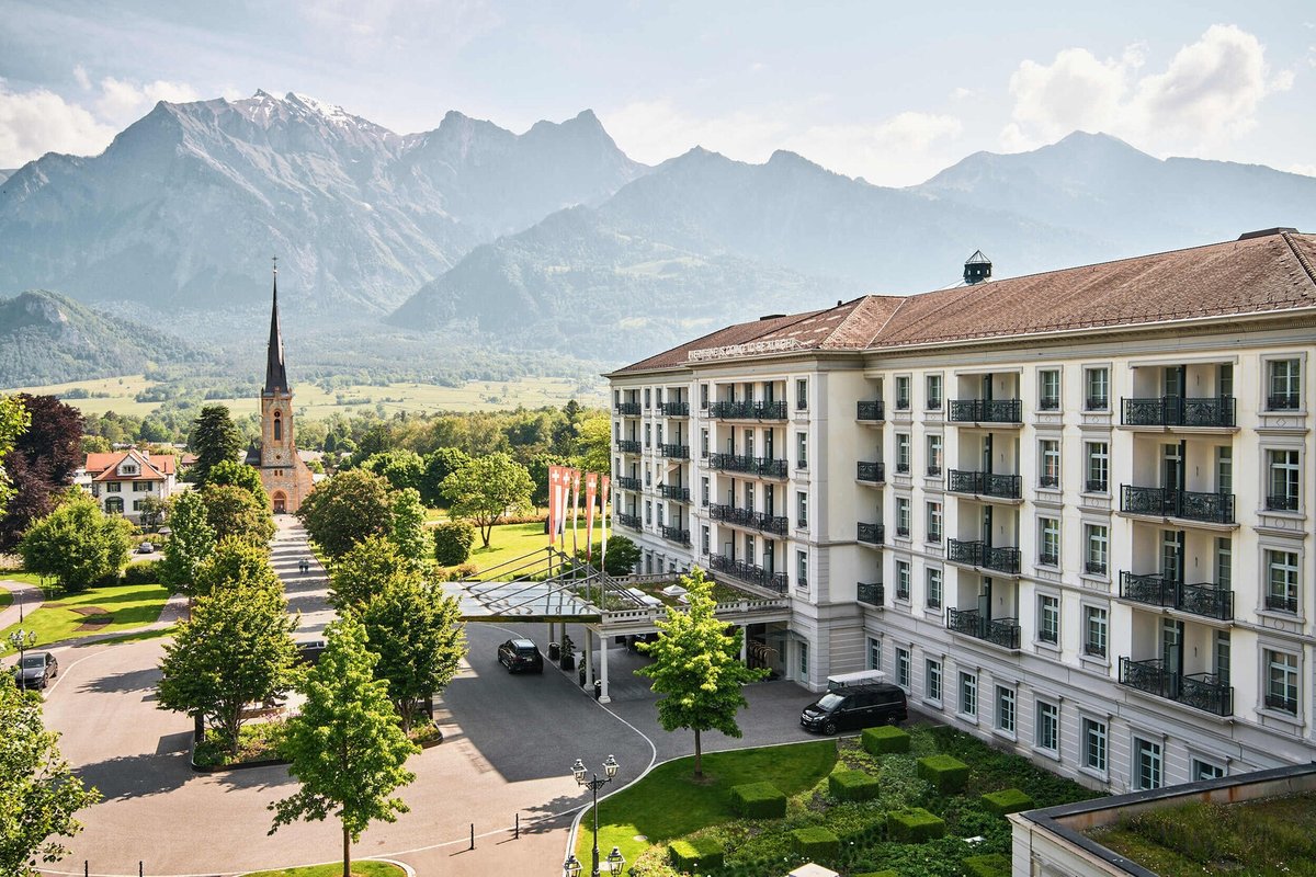 Grand Resort Bad Ragaz Hof exterior — historic Swiss grand hotel with Alpine mountain backdrop, St. Gallen