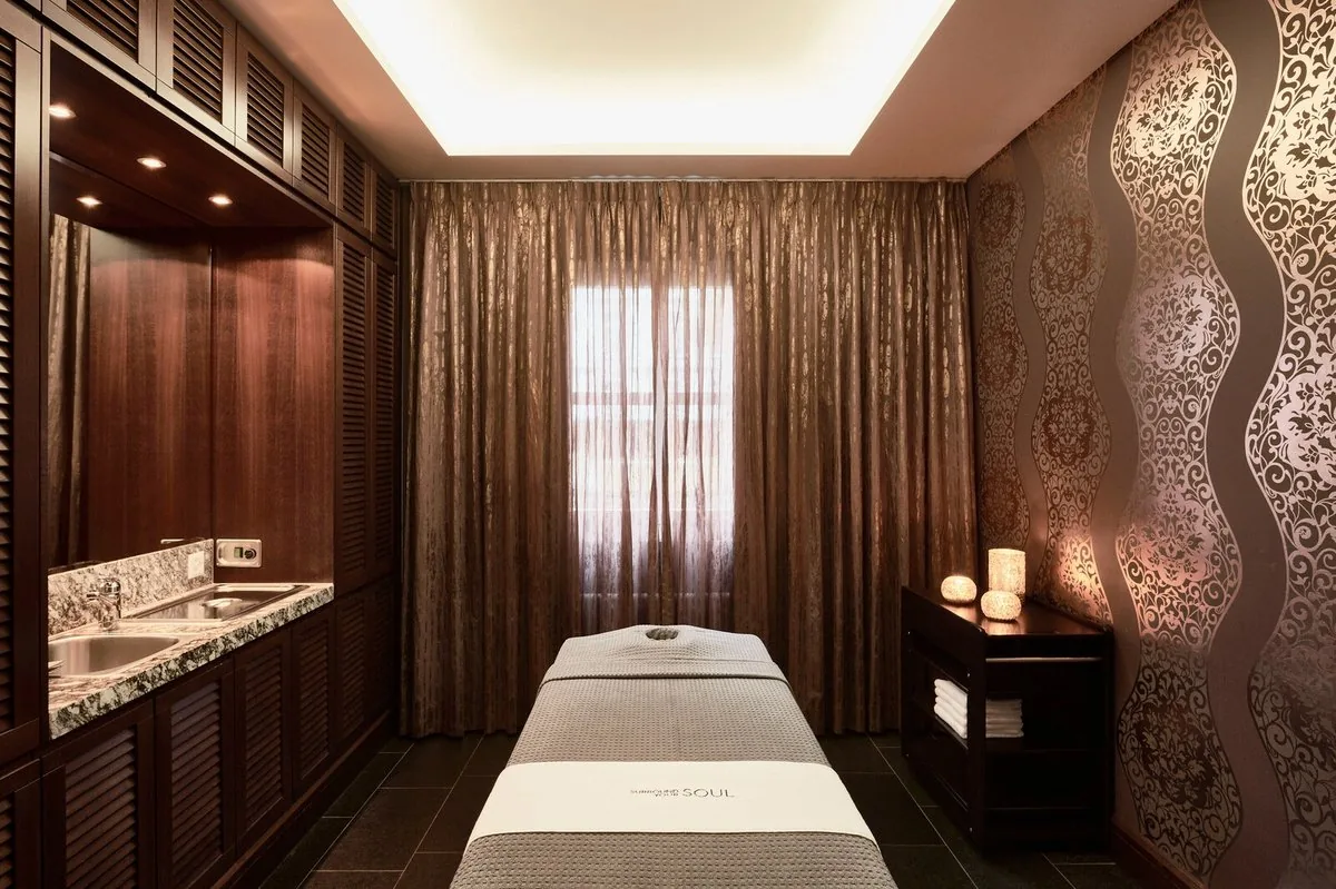 Grand Resort Bad Ragaz Thermal Spa treatment room — luxury wellness treatment suite with candlelit ambience