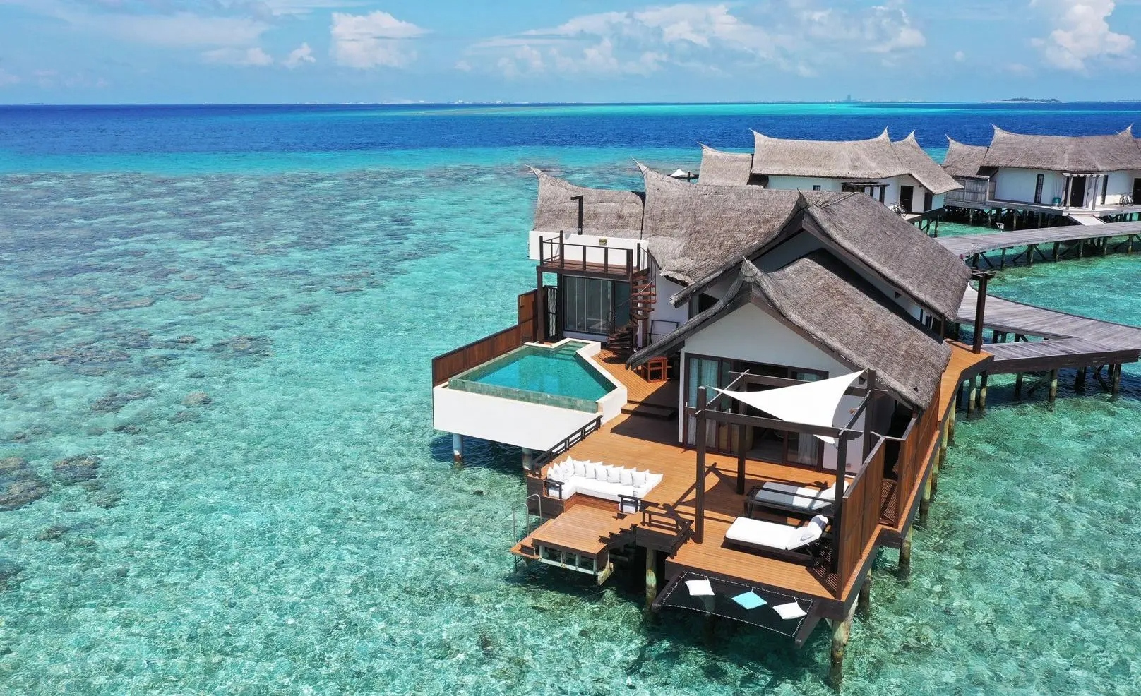 OZEN RESERVE Bolifushi overwater villas with private pools above turquoise reef, South Malé Atoll Maldives
