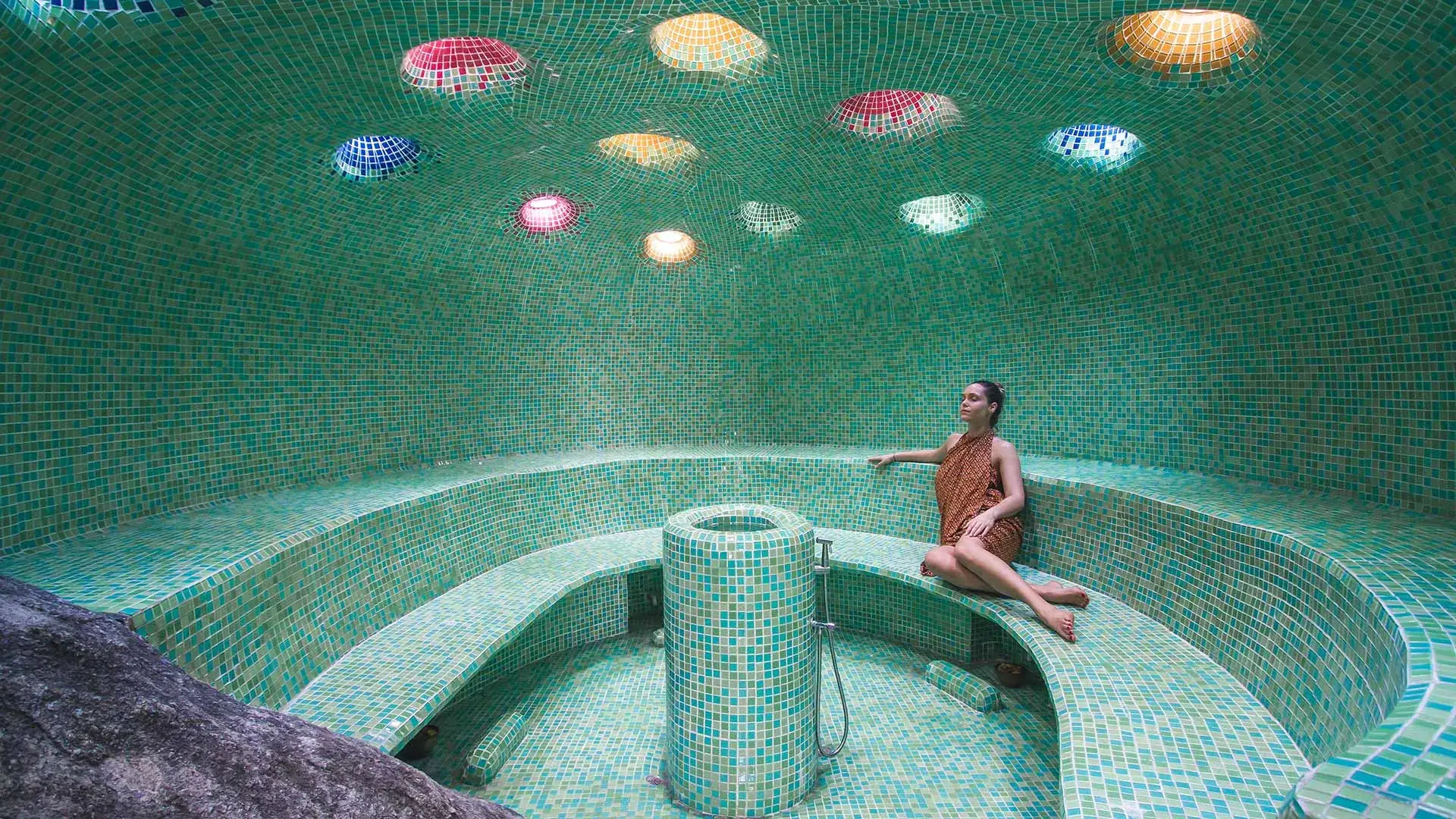Mosaic-tiled steam cavern with colourful glass ceiling lights at Kamalaya Koh Samui wellness spa