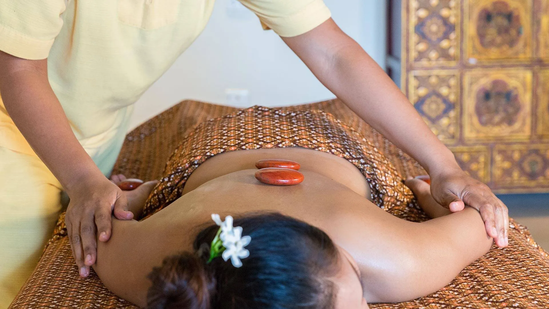 Traditional Three Treasures stone massage therapy with healing crystals at Kamalaya Koh Samui spa
